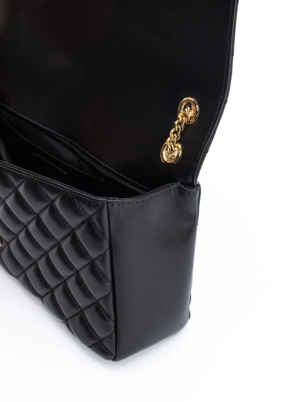 Close-up of quilted black leather handbag with gold chain detail and open flap