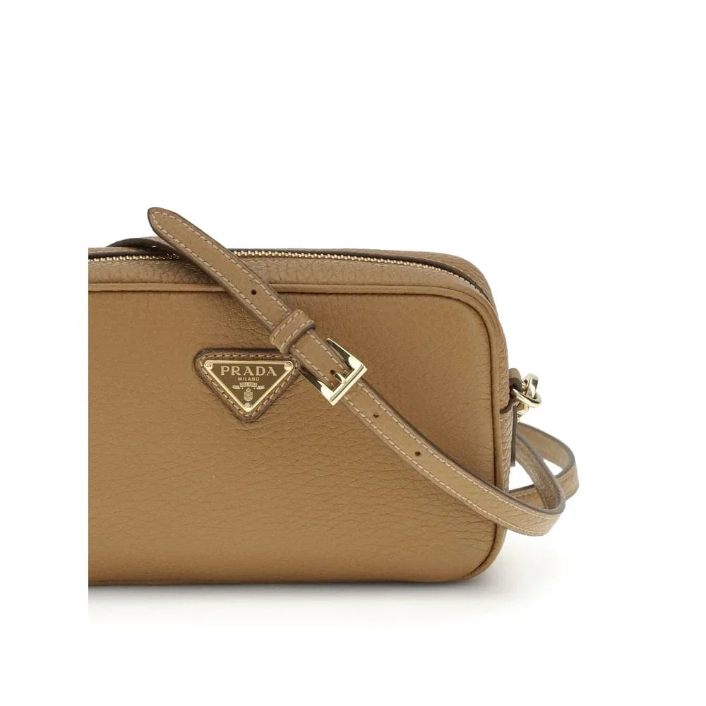 Brown leather crossbody bag with gold Prada logo and adjustable strap on white background
