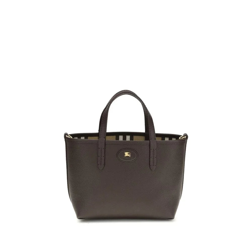 Small black leather tote bag with top handles and gold emblem, striped interior lining