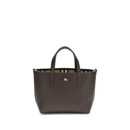 Small black leather tote bag with top handles and gold emblem, striped interior lining