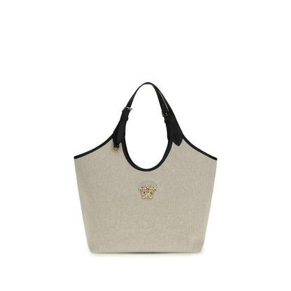 Beige canvas tote bag with black leather handles and gold Medusa head accent, luxury accessory