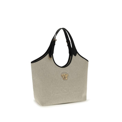 Beige canvas tote bag with black leather handles and gold Medusa head accent
