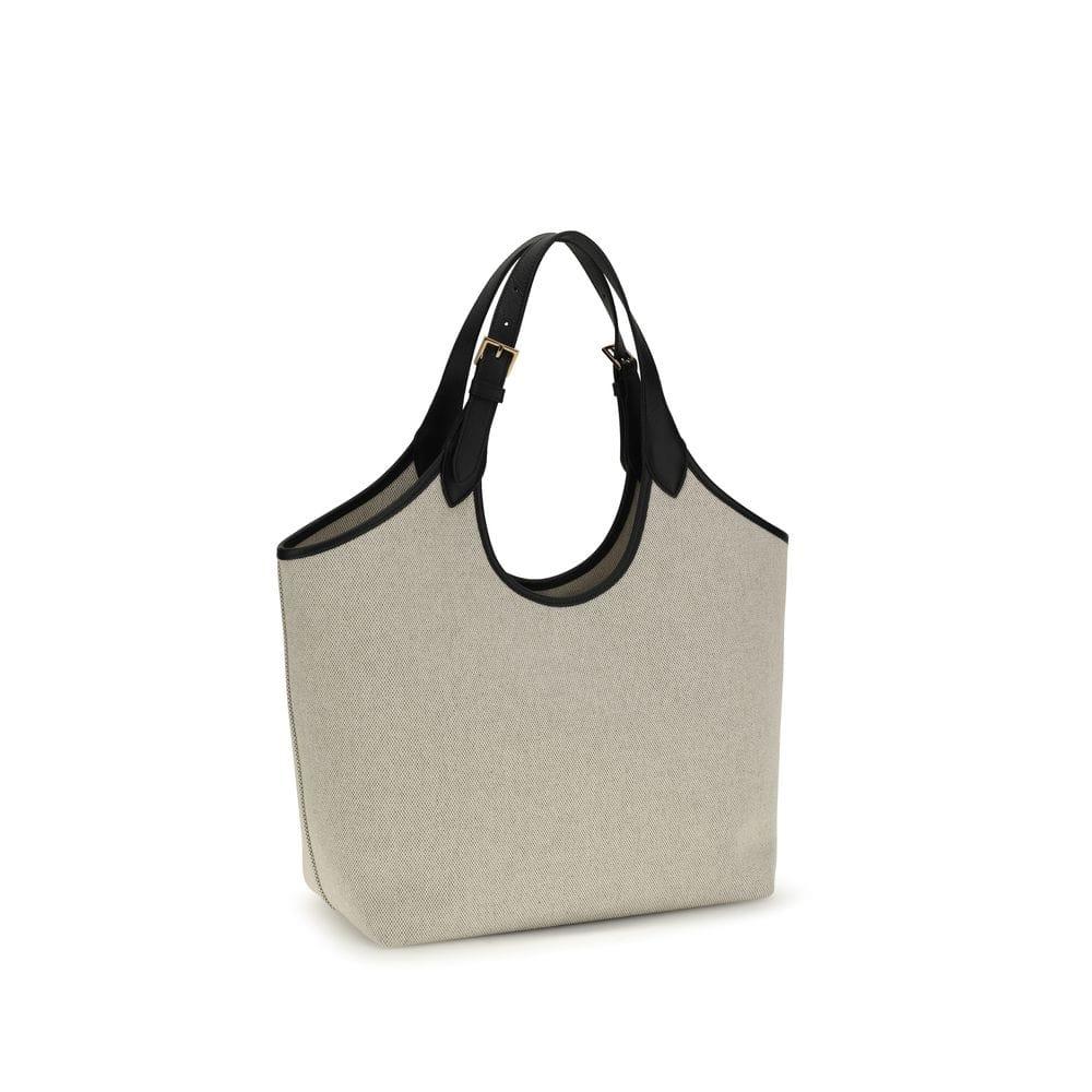 Beige canvas tote bag with black leather handles and gold-tone buckle detail