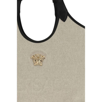 Beige textured designer shoulder bag with black trim and gold Medusa head emblem