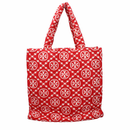 Red designer tote bag with white geometric pattern and textured fabric