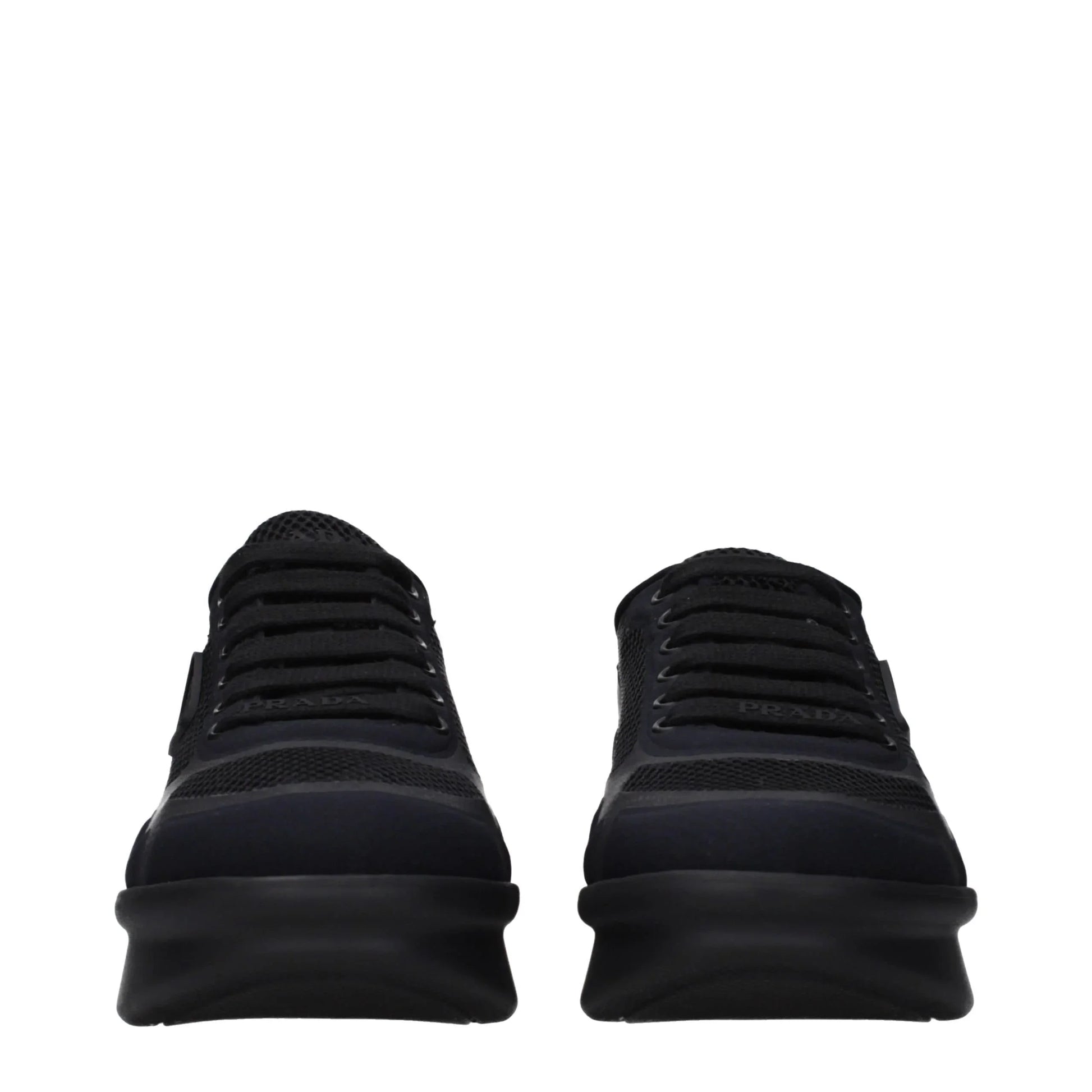 Front view of black designer mesh sneakers with chunky rubber soles and lace-up closure