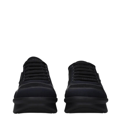 Front view of black designer mesh sneakers with chunky rubber soles and lace-up closure