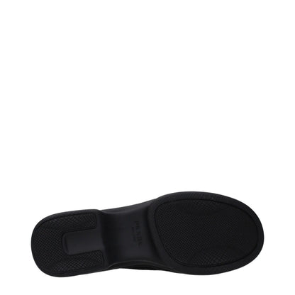 Black textured rubber sole of a designer shoe with branding, shown on white background