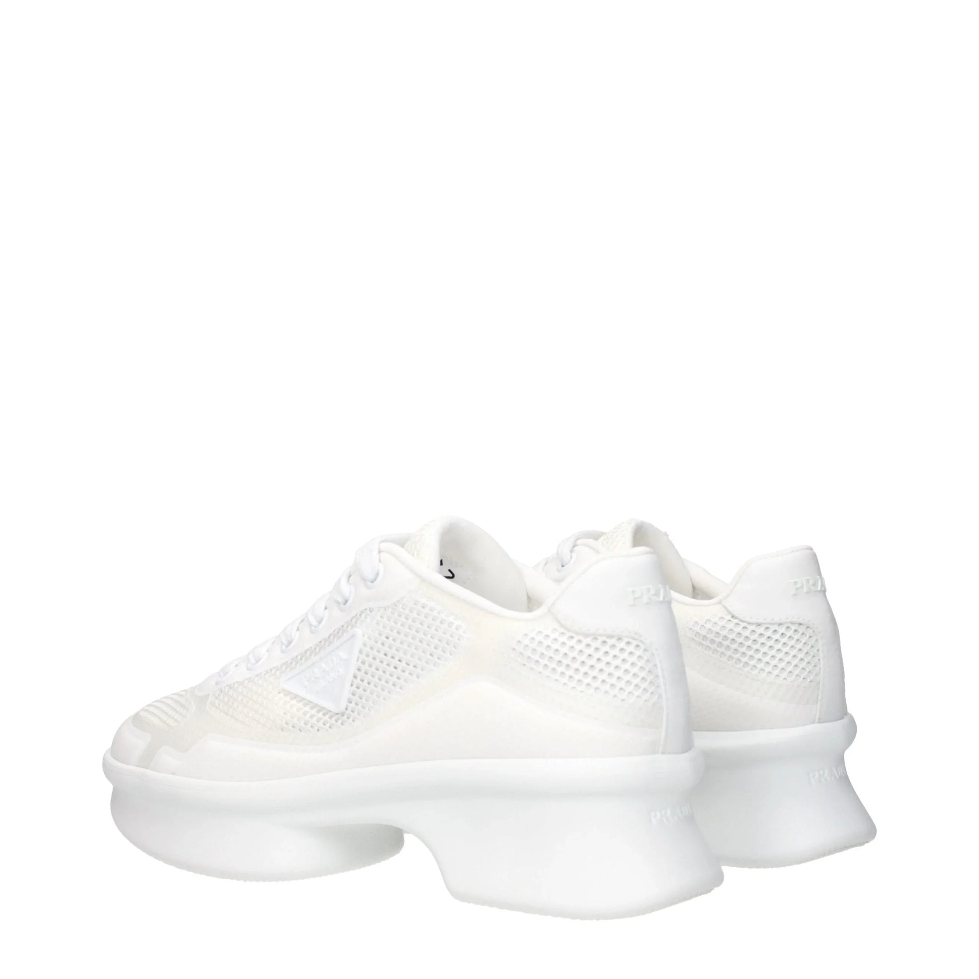 White designer sneakers with chunky sculpted soles and mesh panels, rear angle view