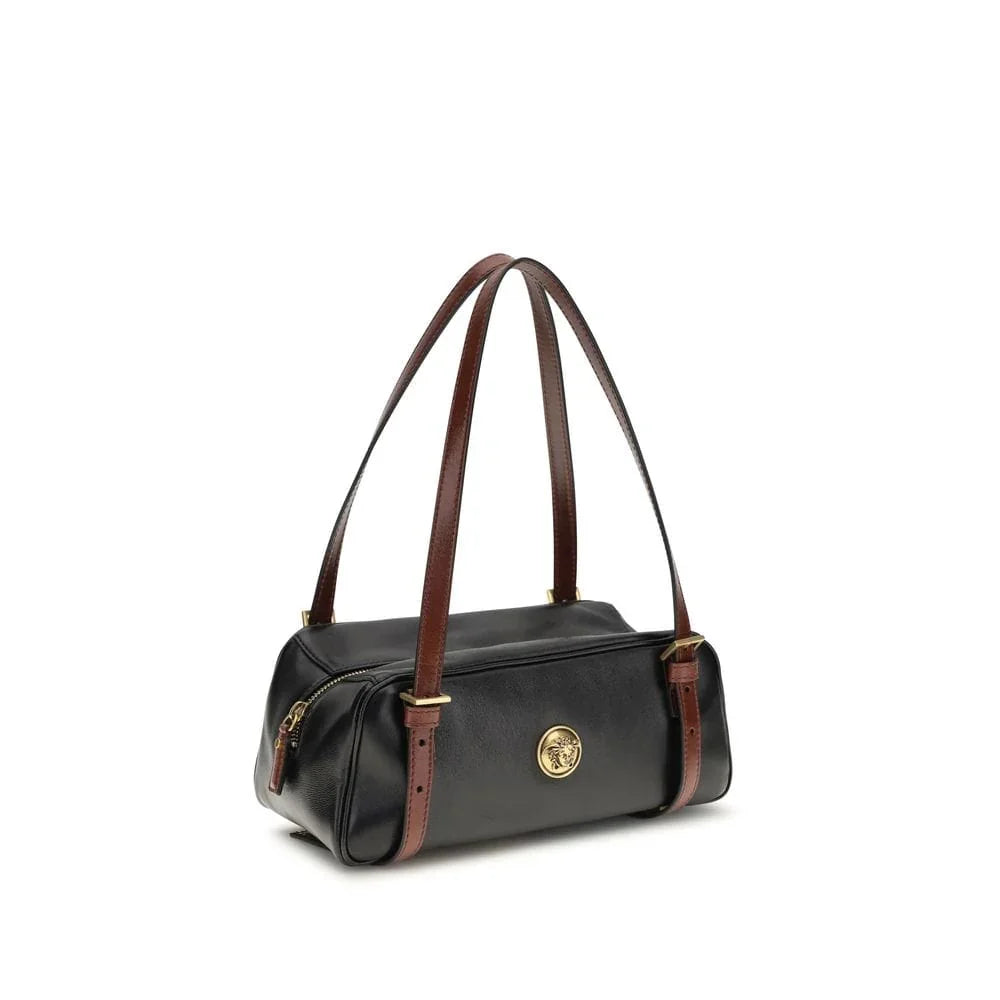 Black leather designer shoulder bag with brown straps and gold medallion accent