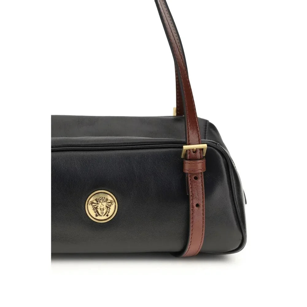Black leather designer handbag with gold medallion and brown adjustable strap