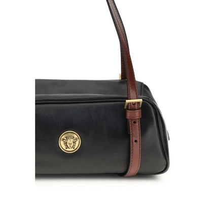 Black leather designer handbag with gold medallion and brown adjustable strap