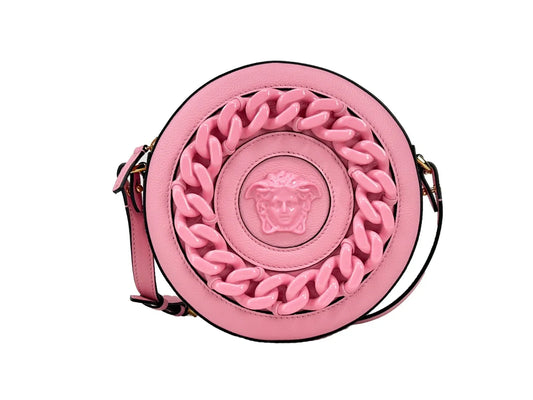 Round pink leather crossbody bag with chunky chain detail and embossed Medusa head