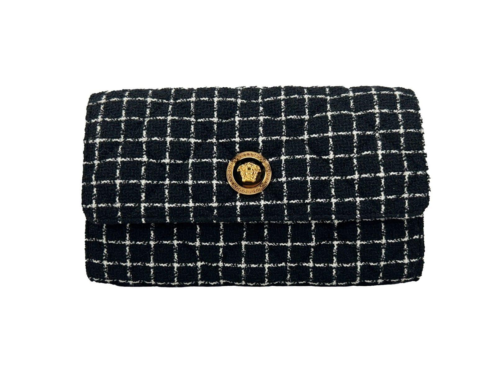 Black and white tweed clutch bag with gold medallion button and grid pattern