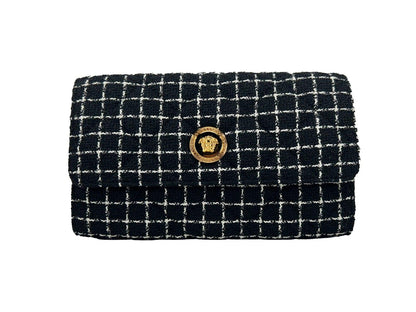 Black and white tweed clutch bag with gold medallion button and grid pattern