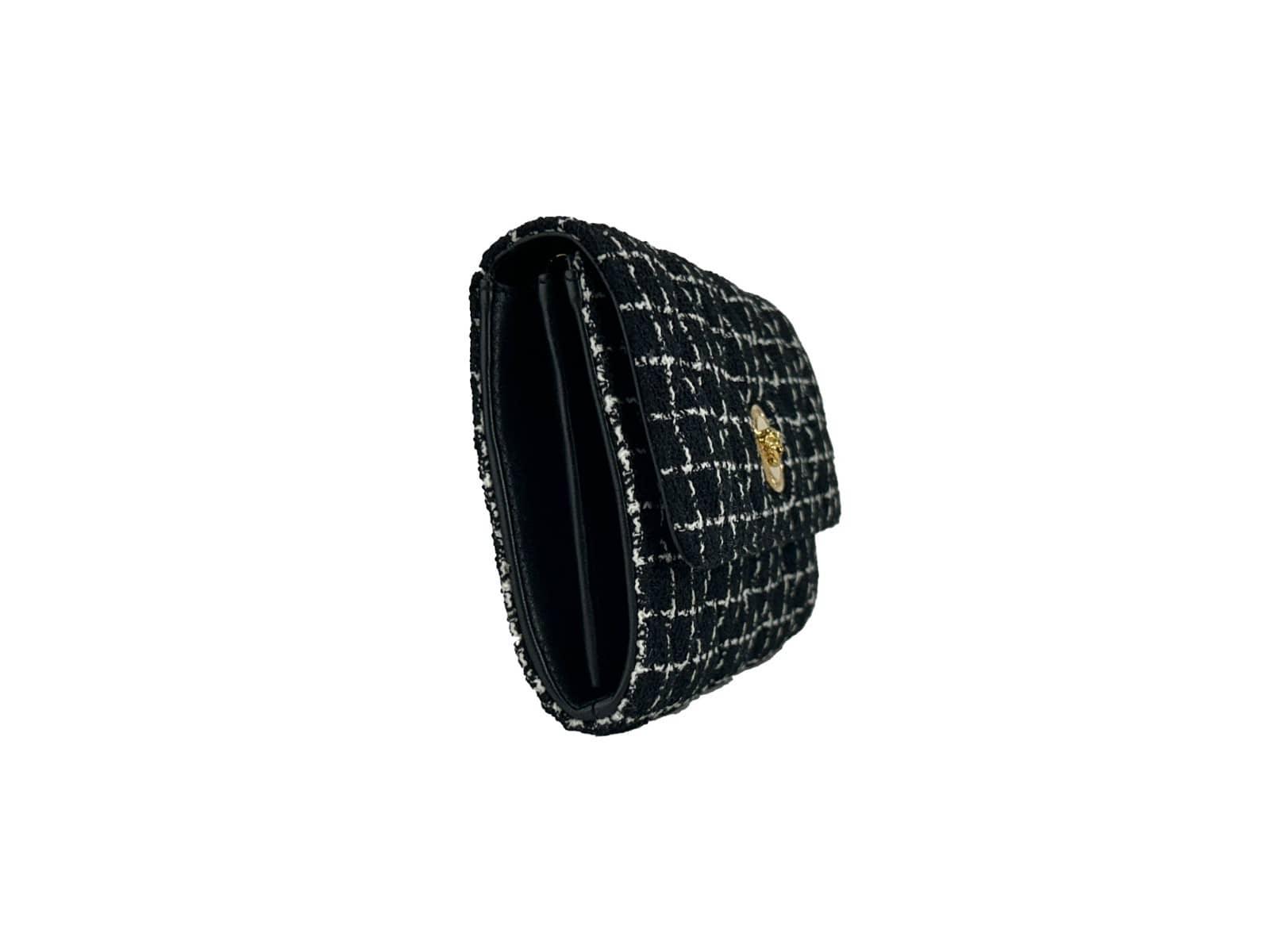Black tweed handbag with gold clasp, luxury designer bag on white background