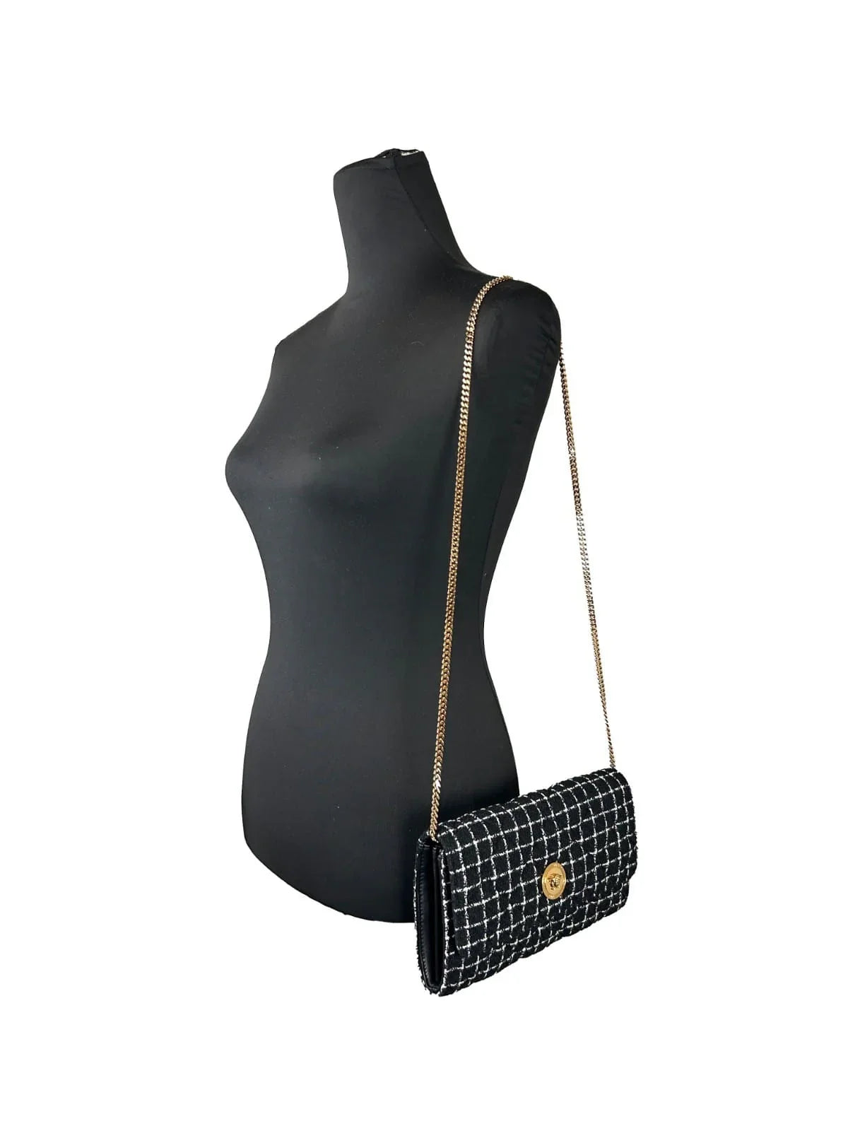 Black and white tweed crossbody bag with gold chain strap on mannequin