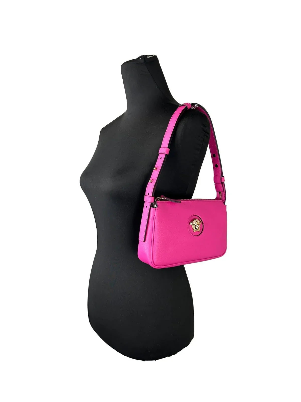 Pink designer shoulder bag with gold medallion on mannequin, luxury handbag fashion