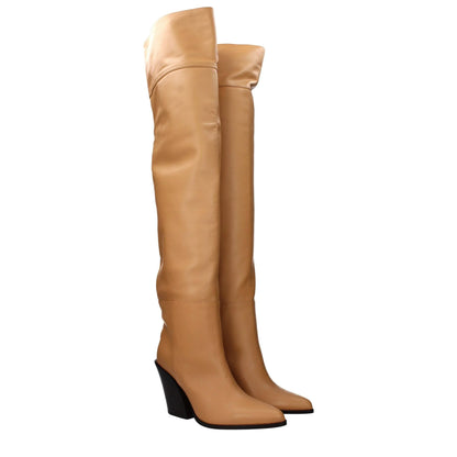 Tan leather over-the-knee wedge boots with pointed toes, studio background.