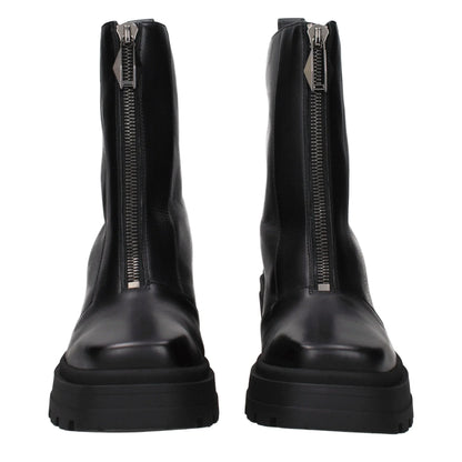 Black leather ankle boots with chunky soles and front zippers, luxury footwear