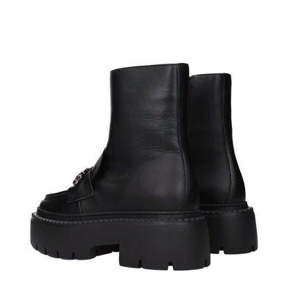Black leather ankle boots with chunky lug sole and metal detail, side view