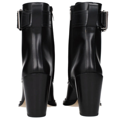 Back view of black leather heeled ankle boots with buckle detail