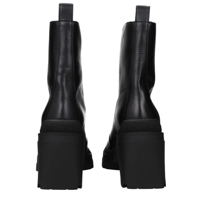 Back view of black leather chunky heel ankle boots with pull tabs