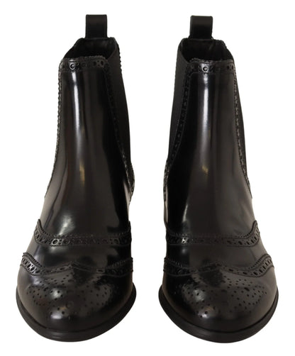 Front view of black leather brogue ankle boots with decorative perforated detailing