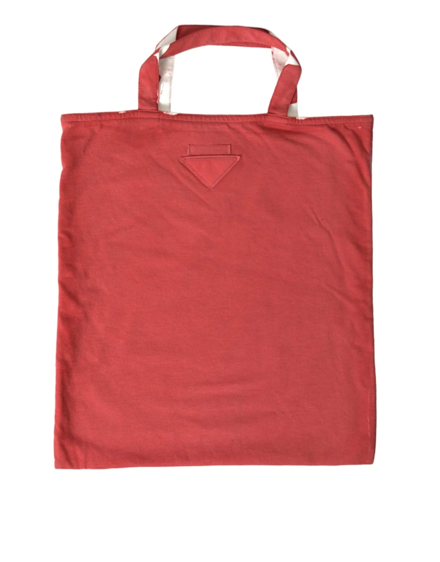 Red cotton tote bag with twin handles and subtle stitched detail on white background