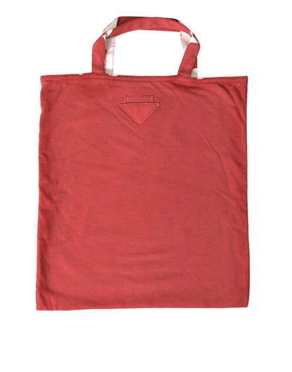 Red cotton tote bag with twin handles and subtle stitched detail on white background
