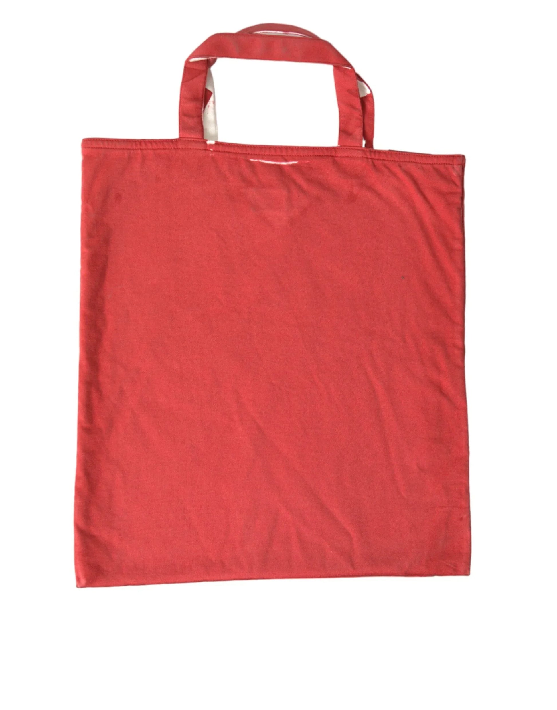 Red cotton tote bag with double handles, flat and unadorned, on white background