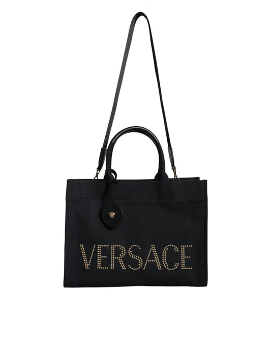 Black Versace tote bag with gold stud accents and a detachable shoulder strap.