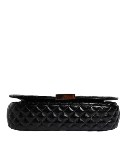 Black quilted leather designer bag with gold clasp on white background