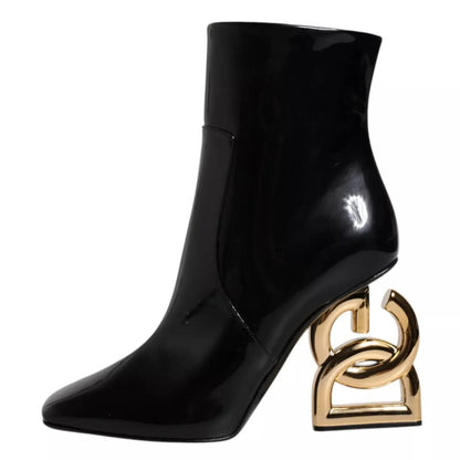 Black patent ankle boot with unique sculptural gold heel, luxury designer footwear