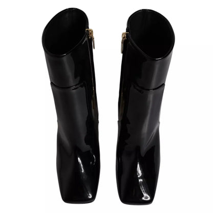 Pair of black patent leather square-toe boots with side zippers, luxury footwear