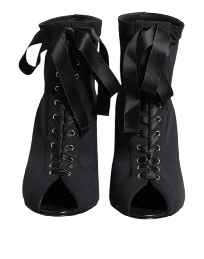 Black lace-up peep toe booties with satin ribbon ties, front view on white background