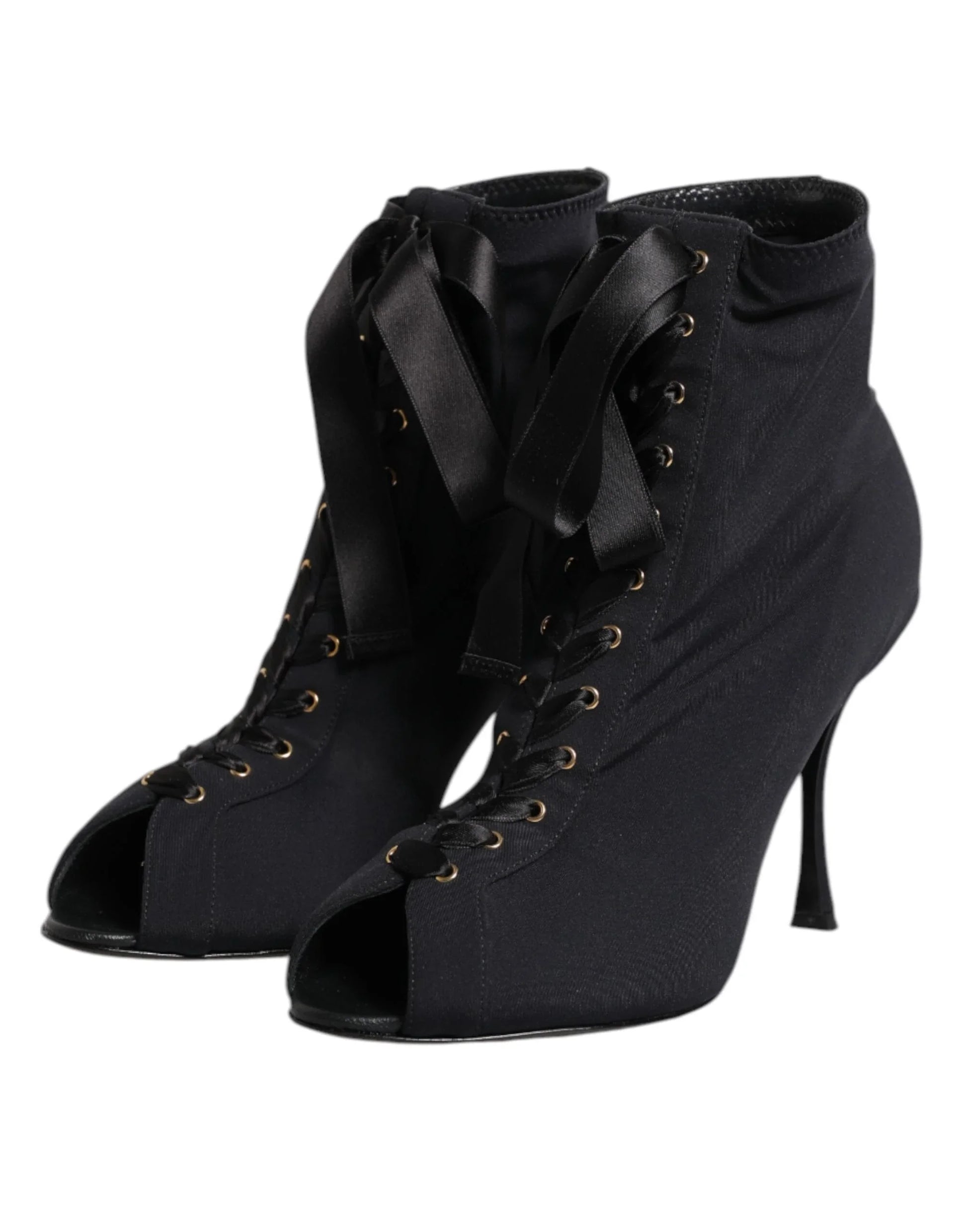 Black lace-up peep toe stiletto ankle boots with ribbon laces on a white background