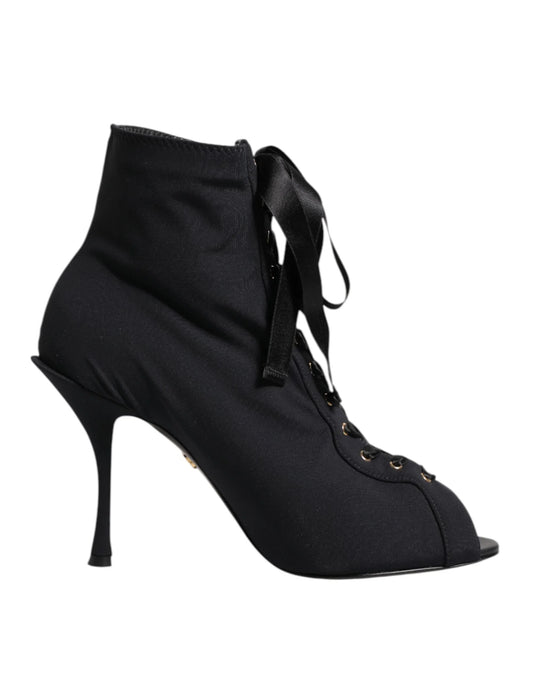 Black lace-up stiletto ankle boot with peep toe and ribbon laces on white background
