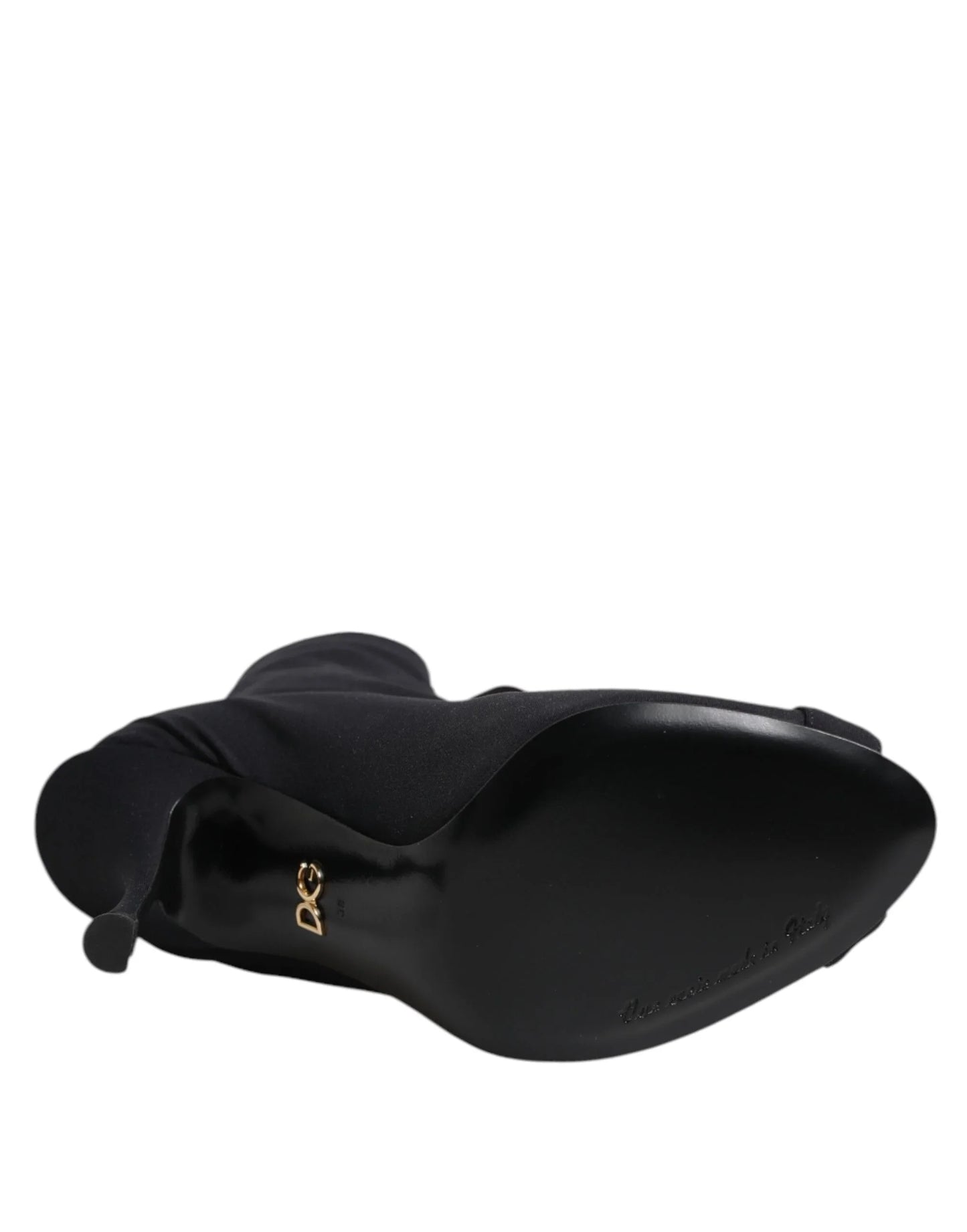 Black high-heeled boot viewed from the sole with gold D&G logo and pointed toe