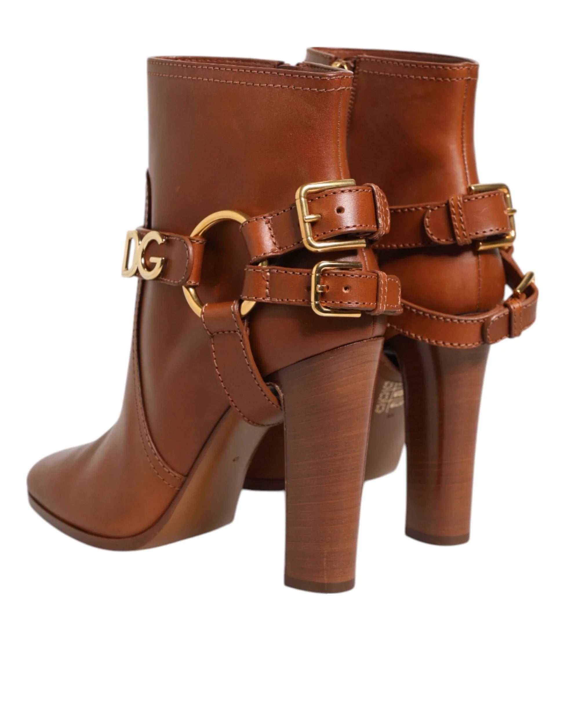 Brown leather high heel ankle boots with gold buckles and decorative hardware