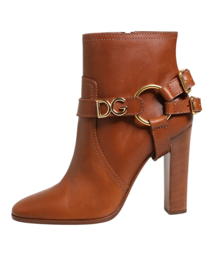 Brown leather ankle boot with block heel, gold DG hardware, and decorative buckle straps