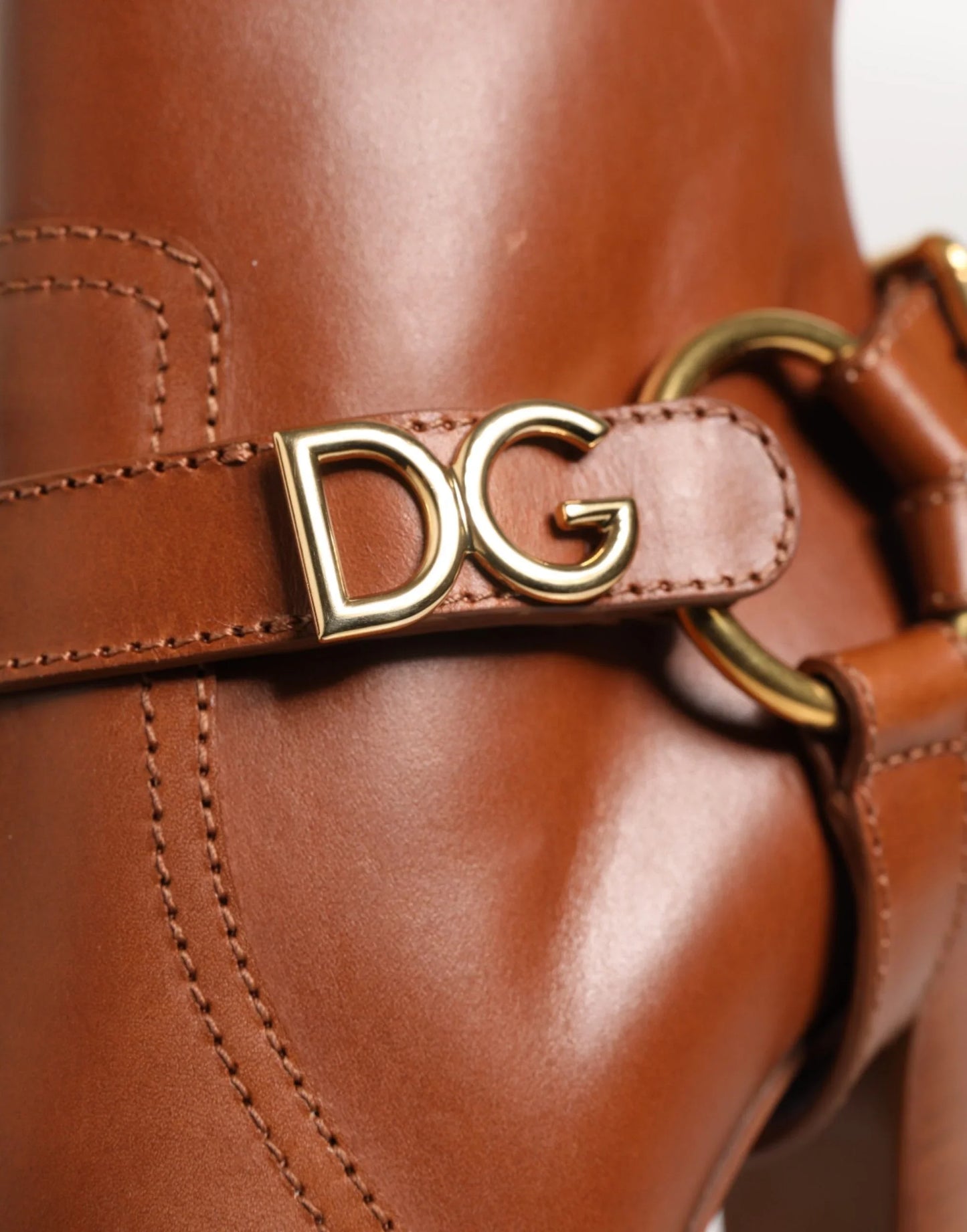 Brown leather designer boot with gold DG logo hardware and detailed stitching