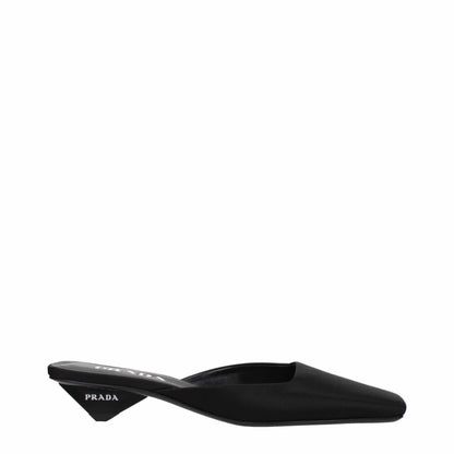 Black pointed-toe mule with low geometric heel and visible logo on the heel side