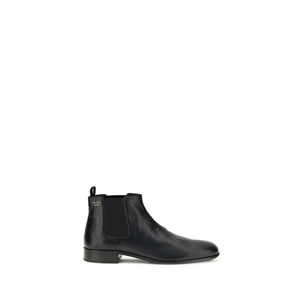 Black leather Chelsea boot with low heel and elastic side panel on white background