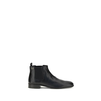 Black leather Chelsea boot with low heel and elastic side panel on white background