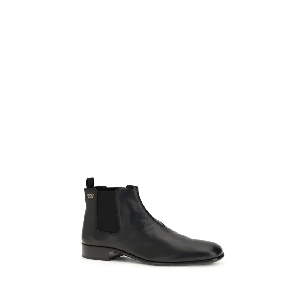 Black leather Chelsea boot with elastic side panel and low heel on white background