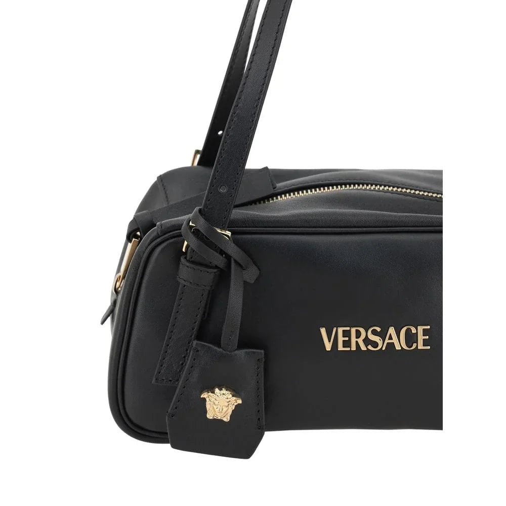 Black leather designer shoulder bag with gold hardware and embossed logo emblem