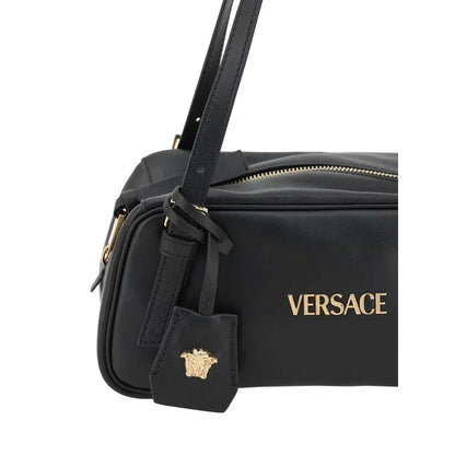 Black leather designer shoulder bag with gold hardware and embossed logo emblem