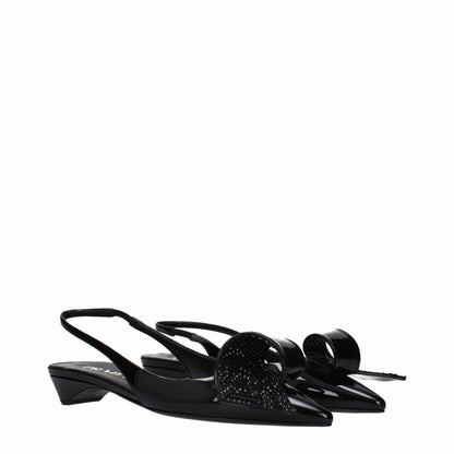 Black slingback kitten heel shoes with pointed toes and bow details on white background