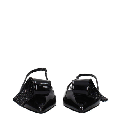 Black patent leather slingbacks with pointed toes and oversized decorative bows